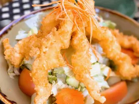 Golden crispy shrimp salad over fresh greens with rich, creamy house dressing