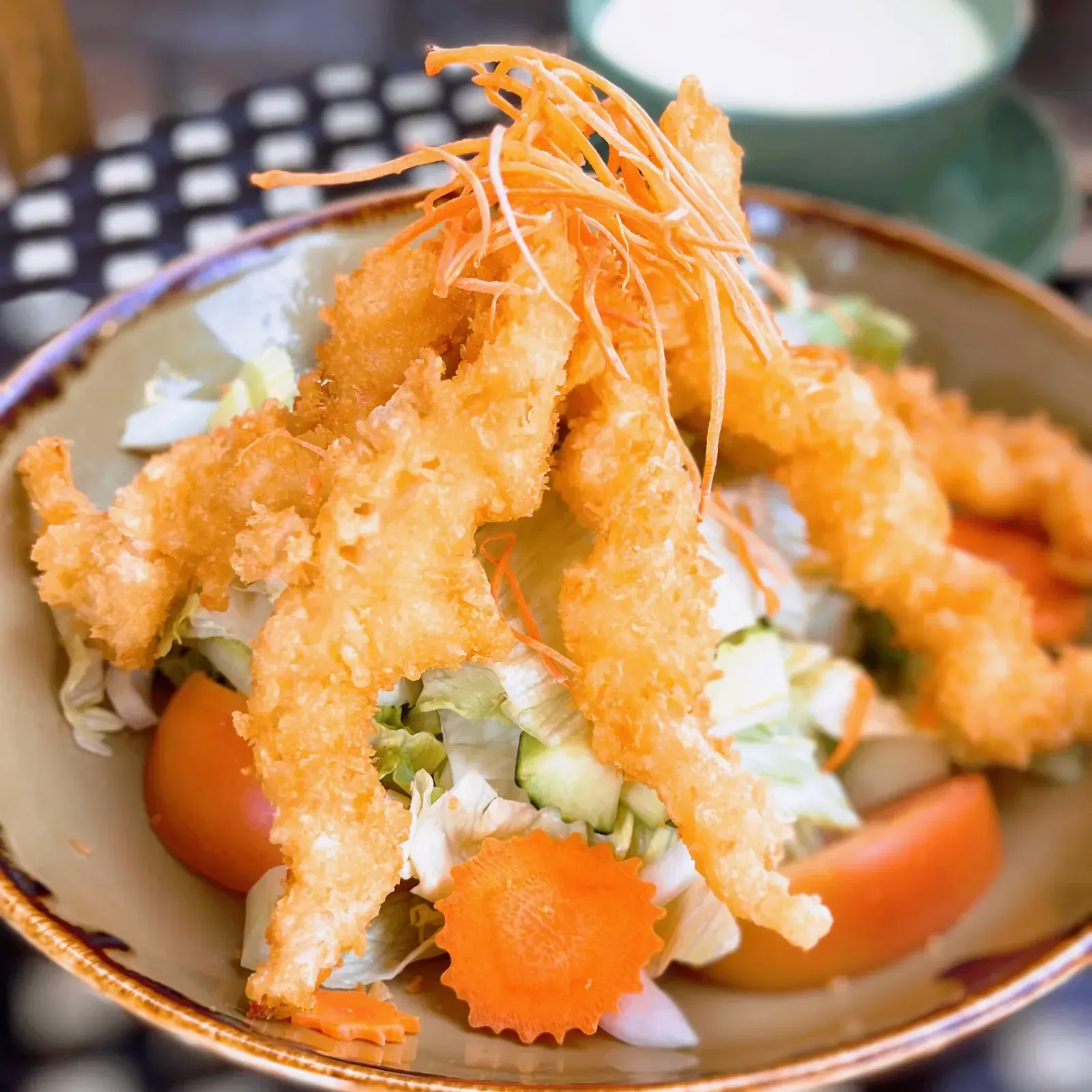 Golden fried shrimp salad with crisp greens, cucumber and zesty Thai lime dressing