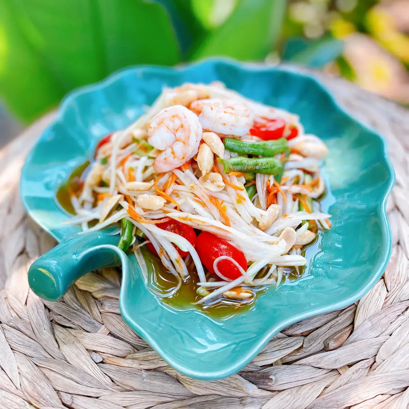 Shredded green papaya salad with tomato, green bean, shrimp and roasted peanuts
