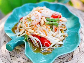 Shredded green papaya salad with tomato, green bean, shrimp and roasted peanuts