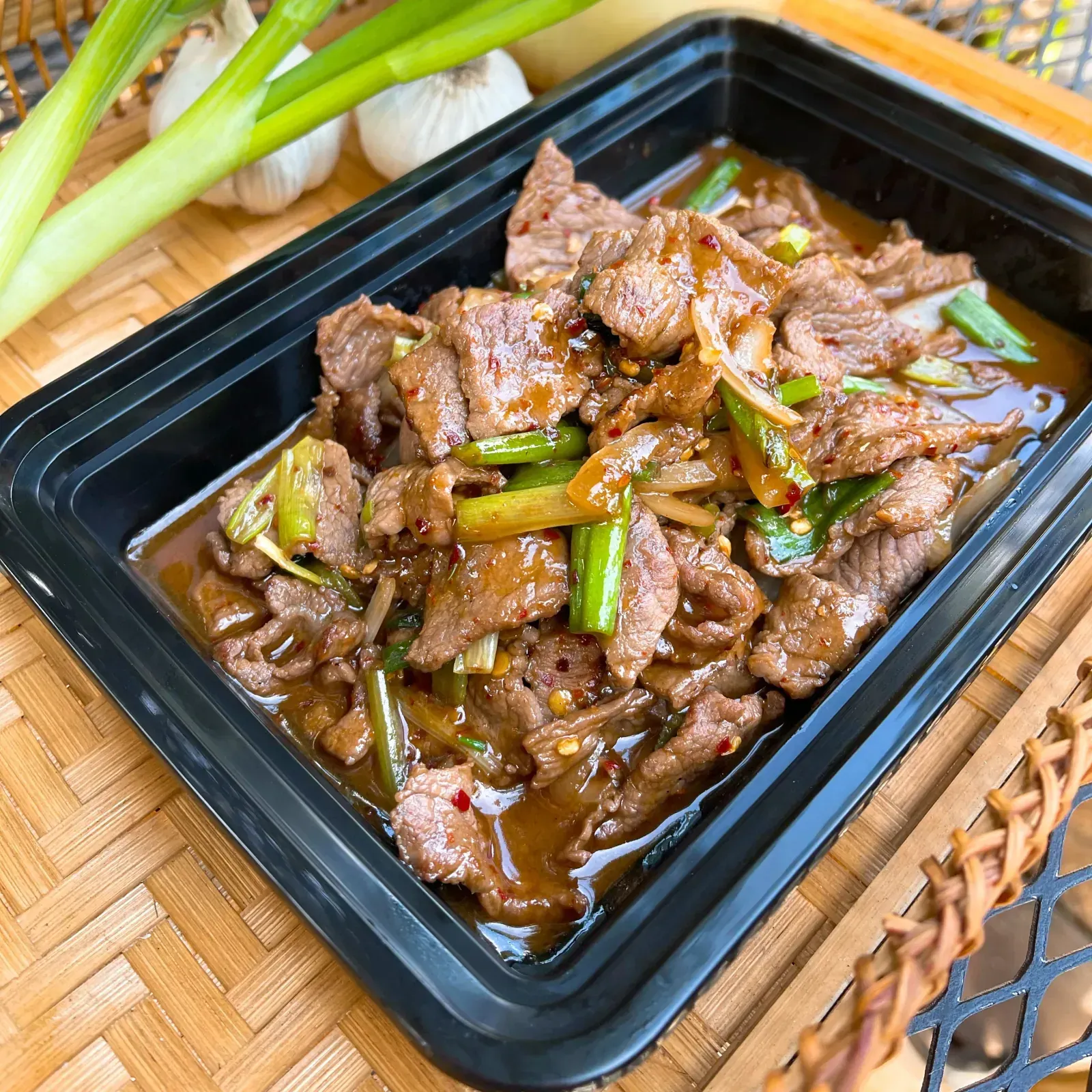 Mongolian beef stir-fried with white and green onions in savory homemade brown sauce