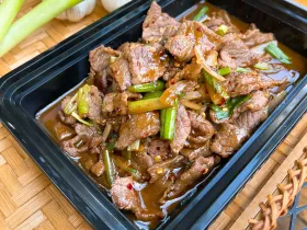 Mongolian beef stir-fried with white and green onions in savory homemade brown sauce