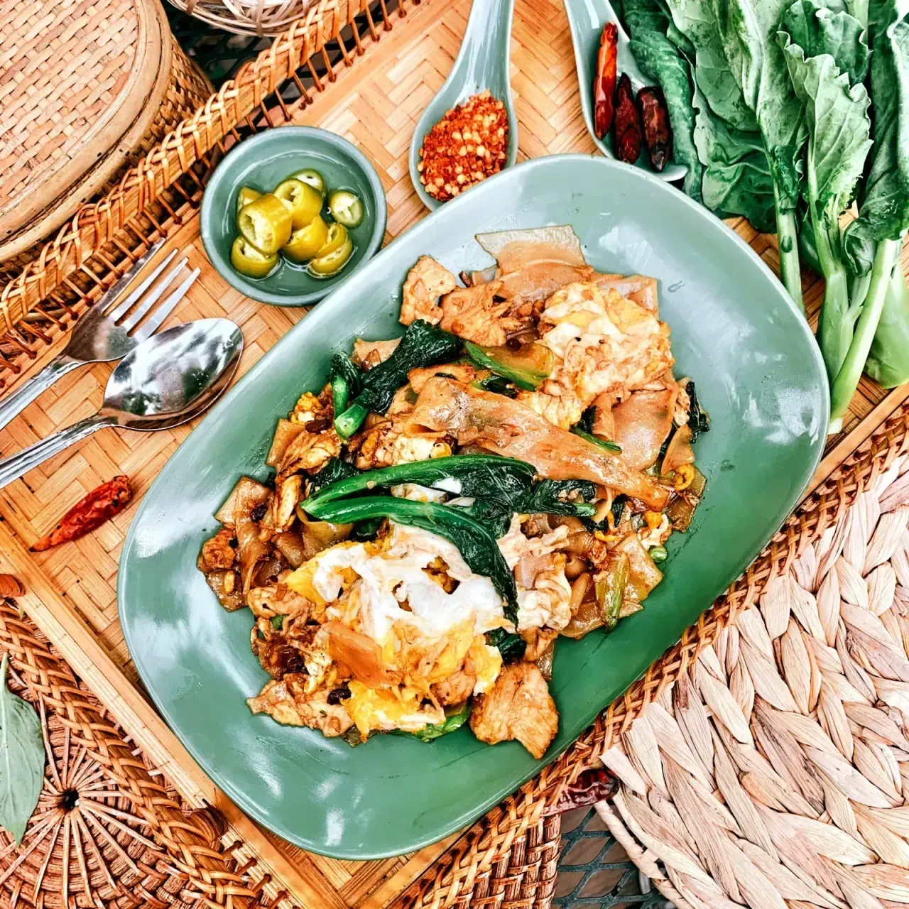 Pad See-Iew wide rice noodles stir-fried with Chinese broccoli and brown egg