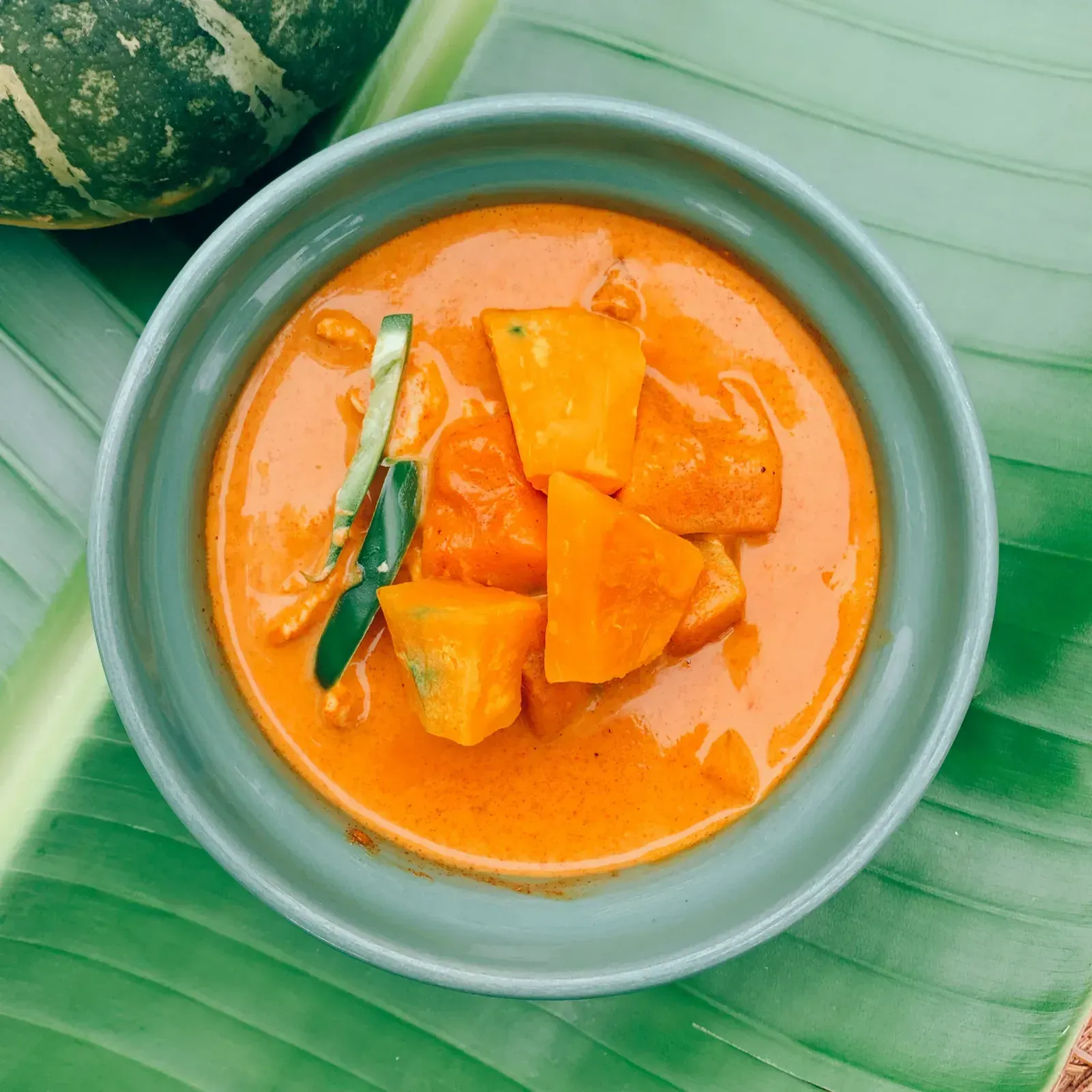 Pumpkin curry with kabocha squash, coconut milk and fresh Thai basil leaves