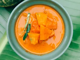 Pumpkin curry with kabocha squash, coconut milk and fresh Thai basil leaves