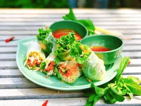 Fresh Thai summer rolls in rice paper served with peanut and sweet sour sauces