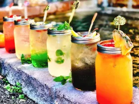 Thai iced tea and Thai iced coffee poured over ice in tall glasses